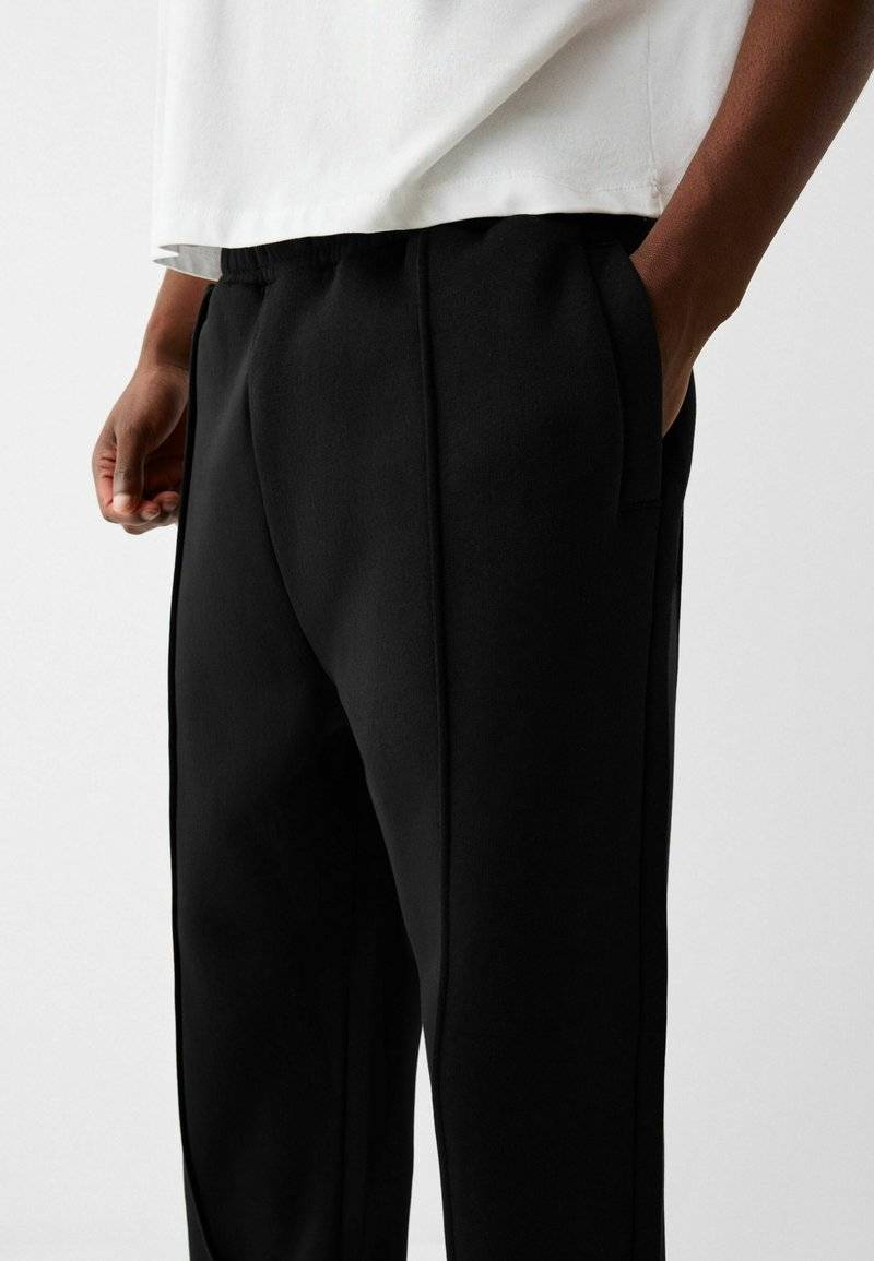 Bershka Bershka WIDE - Tracksuit bottoms - black Saisonschlussverkauf