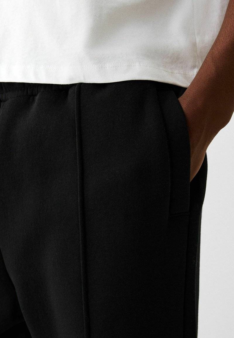 Bershka Bershka WIDE - Tracksuit bottoms - black Saisonschlussverkauf