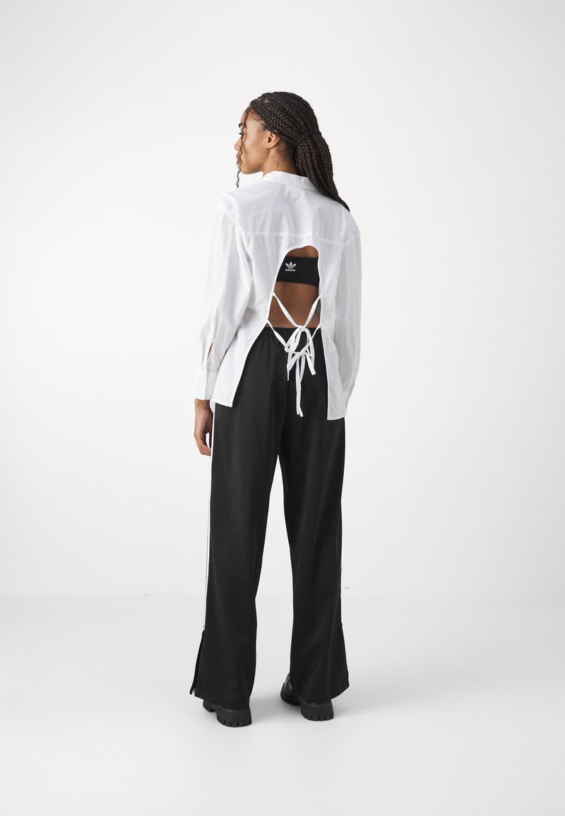 adidas Originals adidas Originals FBIRD LOOSE - Tracksuit bottoms - black Meist gekauft