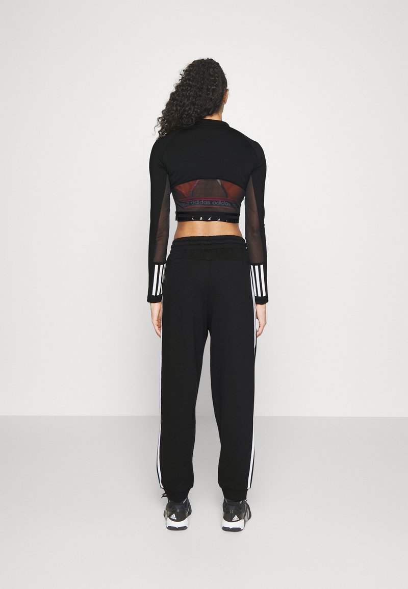 adidas Sportswear adidas Sportswear ESSENTIALS 3-STRIPES LOOSE-FIT - Tracksuit bottoms Räumungsverkauf