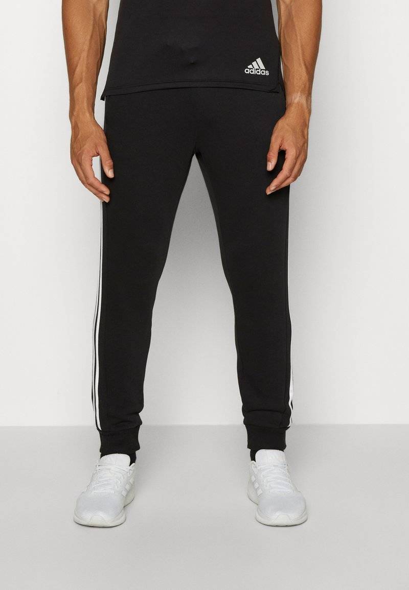 adidas Sportswear adidas Sportswear ESSENTIALS TAPERED CUFF 3 STRIPES PANTS - Tracksuit bottoms - black white Neueste Mode