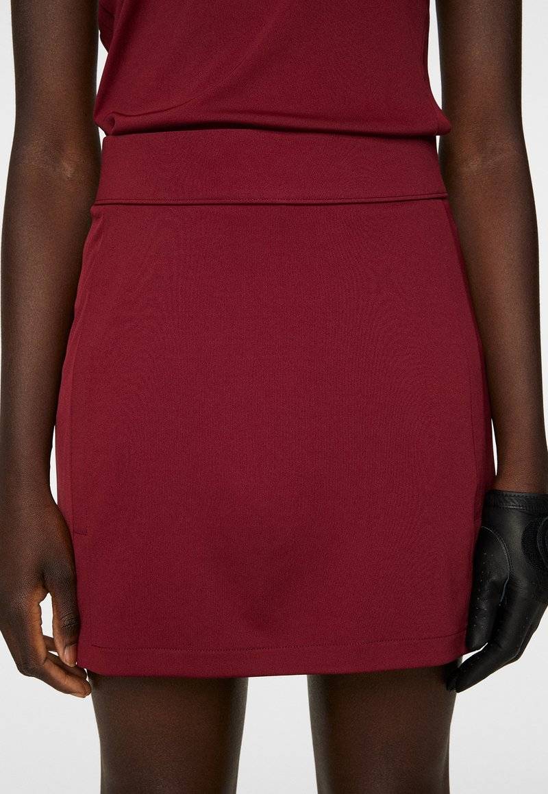 J.LINDEBERG Sports J.LINDEBERG Sports AMELIE MID - Sports skirt - cabernet Letzte 3 Tage